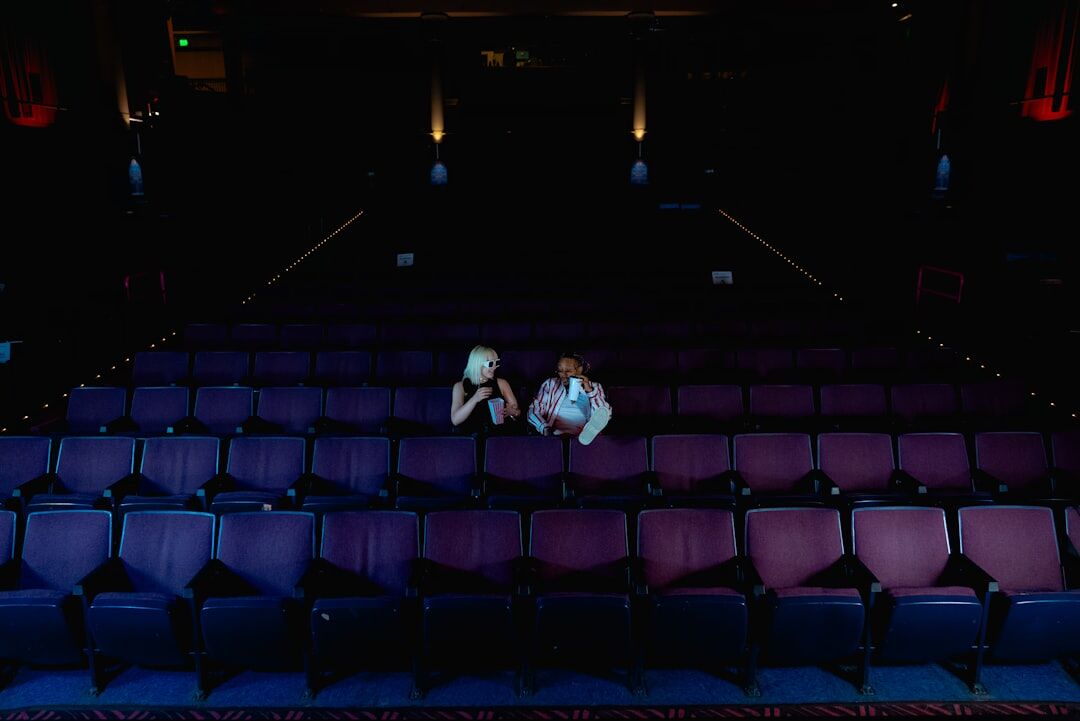 Croatian seniors watching a theatre performance in a community hall