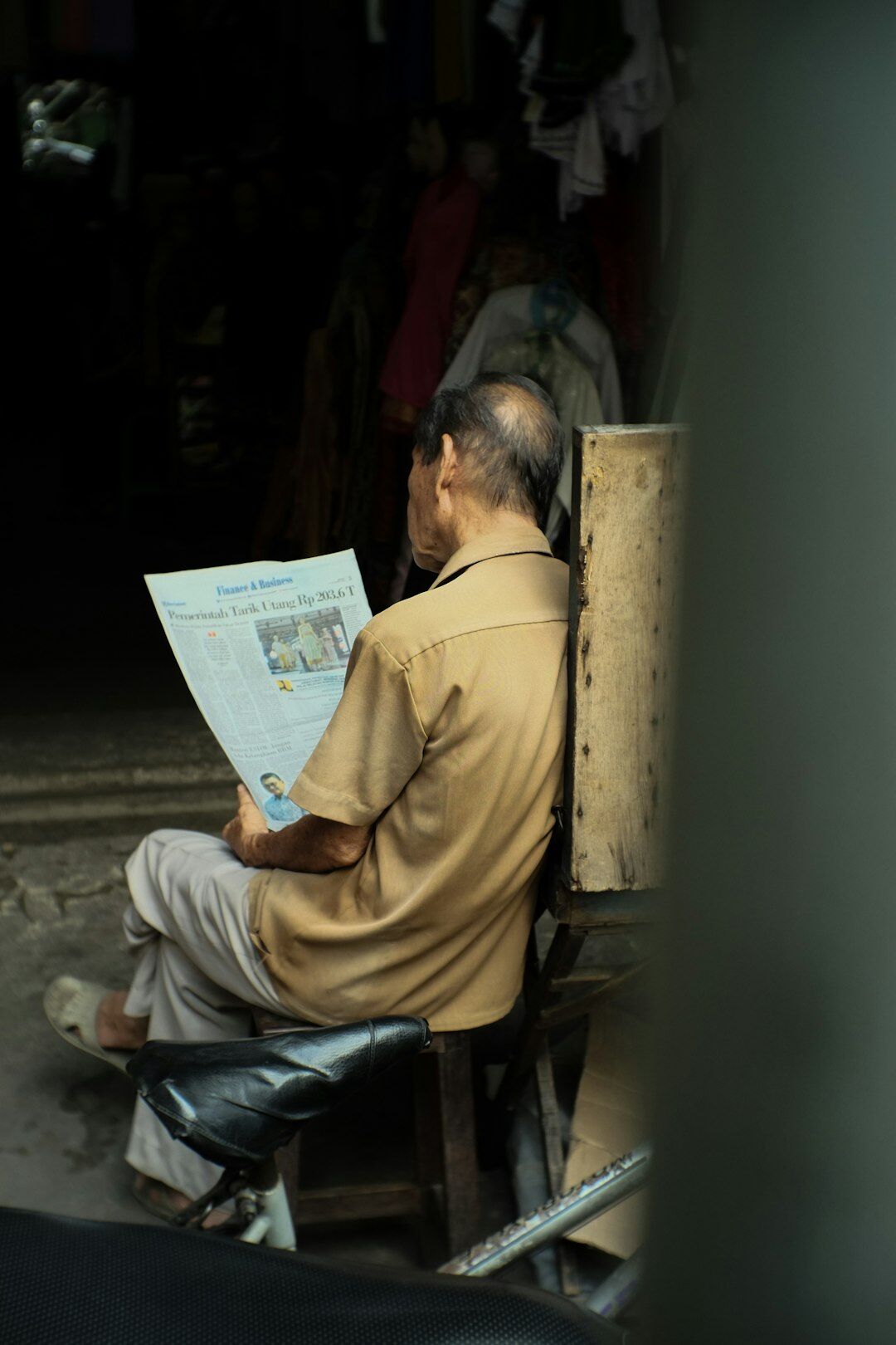 elderly person reading newspaper