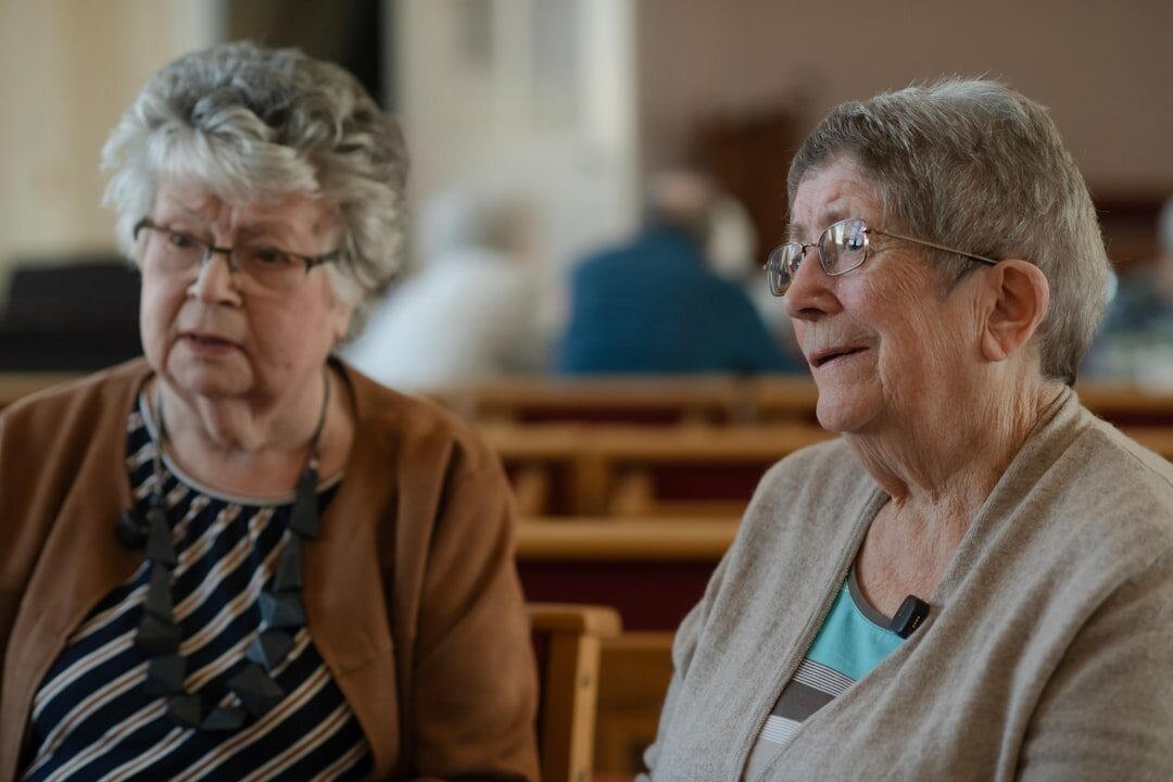 Croatian seniors chatting and drinking coffee inside a community center