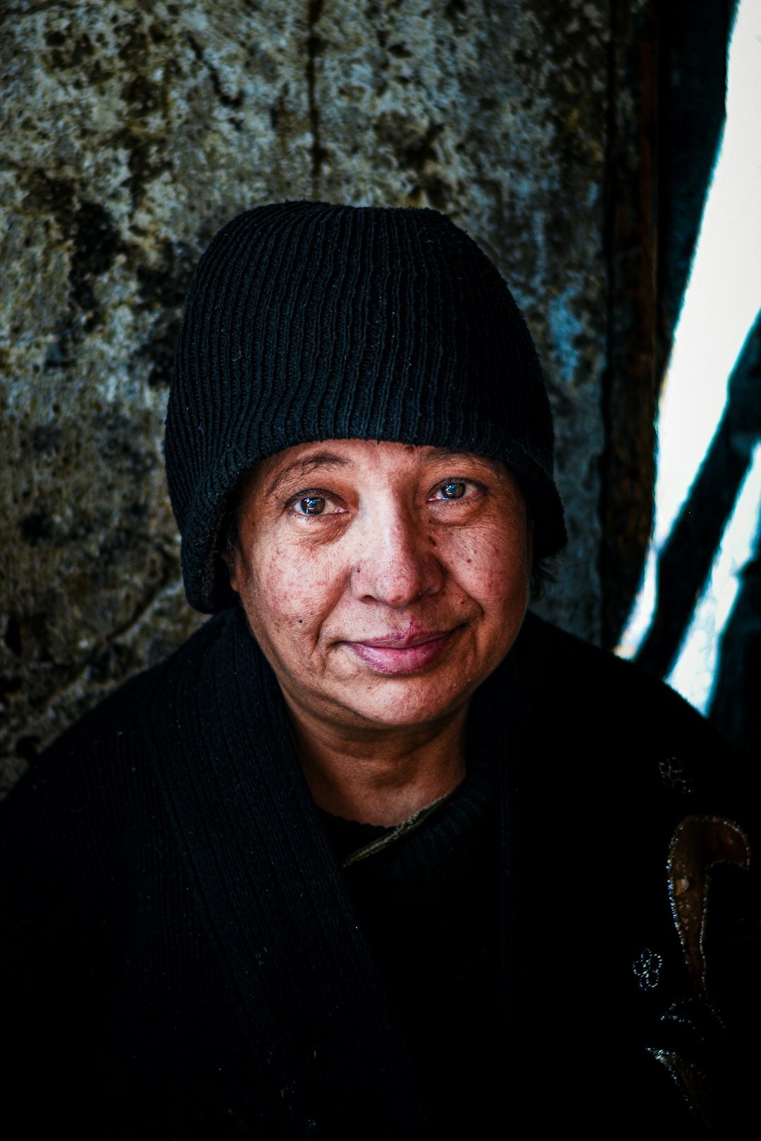 Studio portrait of a cheerful older Croatian woman community volunteer coordinator