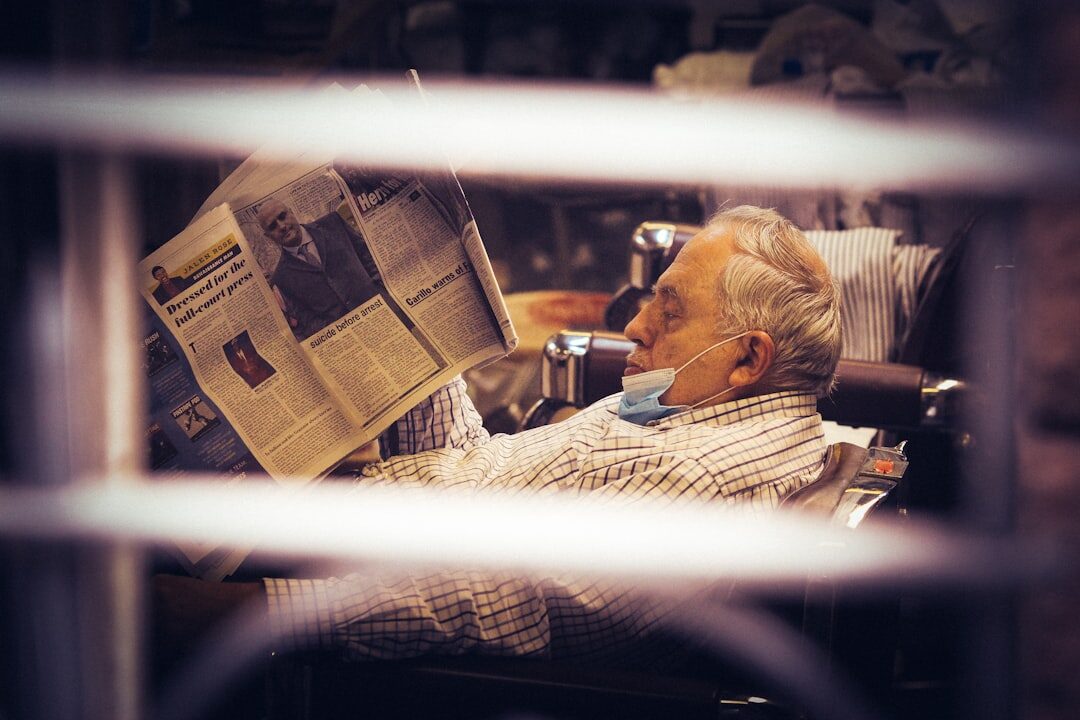 elderly person reading newspaper